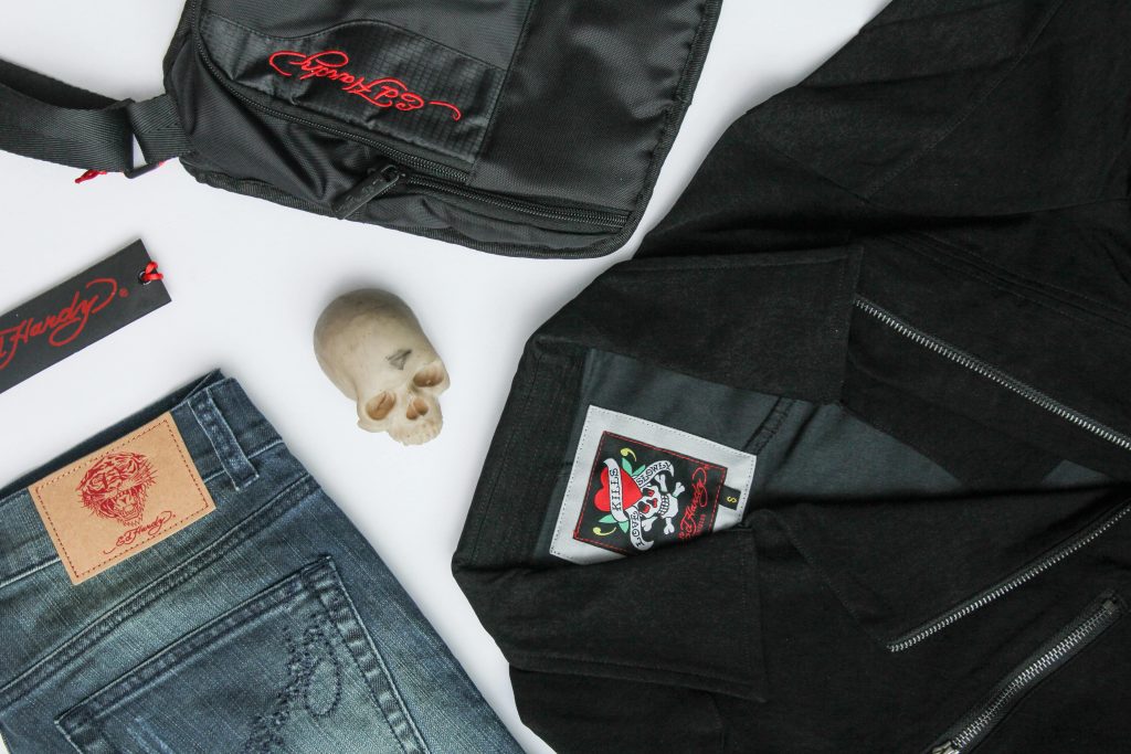 Flat lay of stylish fashion pieces with a skull accent, highlighting edgy style and cool designs.